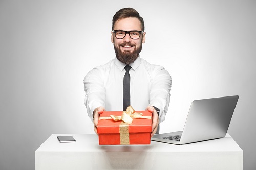Holiday Gift Ideas - man holding wrapped gift 